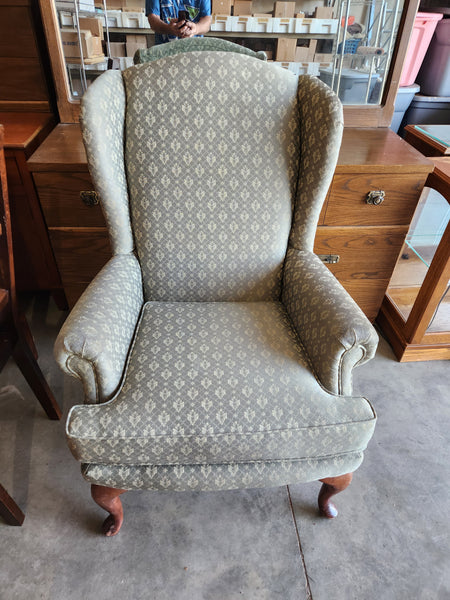 Green patterned wing back chair